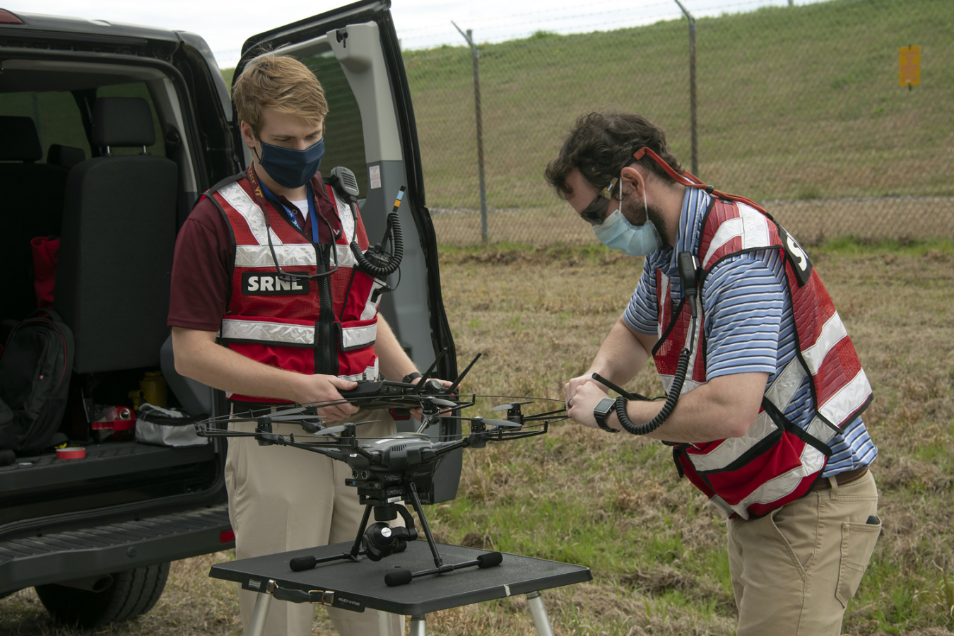 Savannah River National Laboratory employees Dalton Hare, left, and Jeff Steedley prepare a drone for flight to inspect engineered protective covers at remediated waste sites at the Savannah River Site.