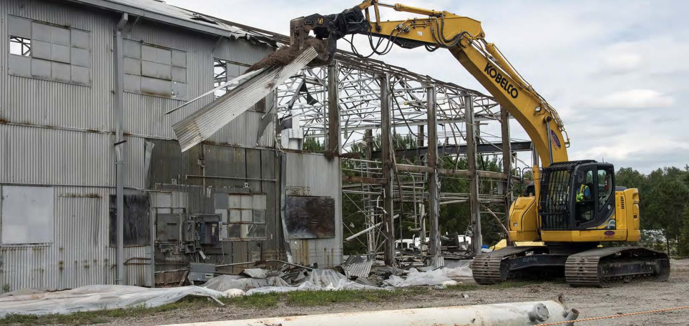 Excavator Demoing Ford Building