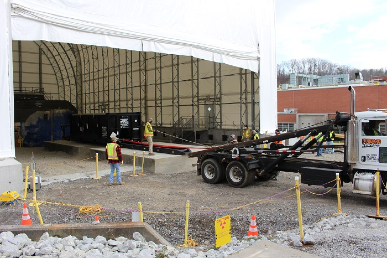 UCOR installed a unique intermodal rail system designed by engineers. The system provides a safe way to remove demolition debris from a space-limited tent area at the former Radioisotope Development Lab.