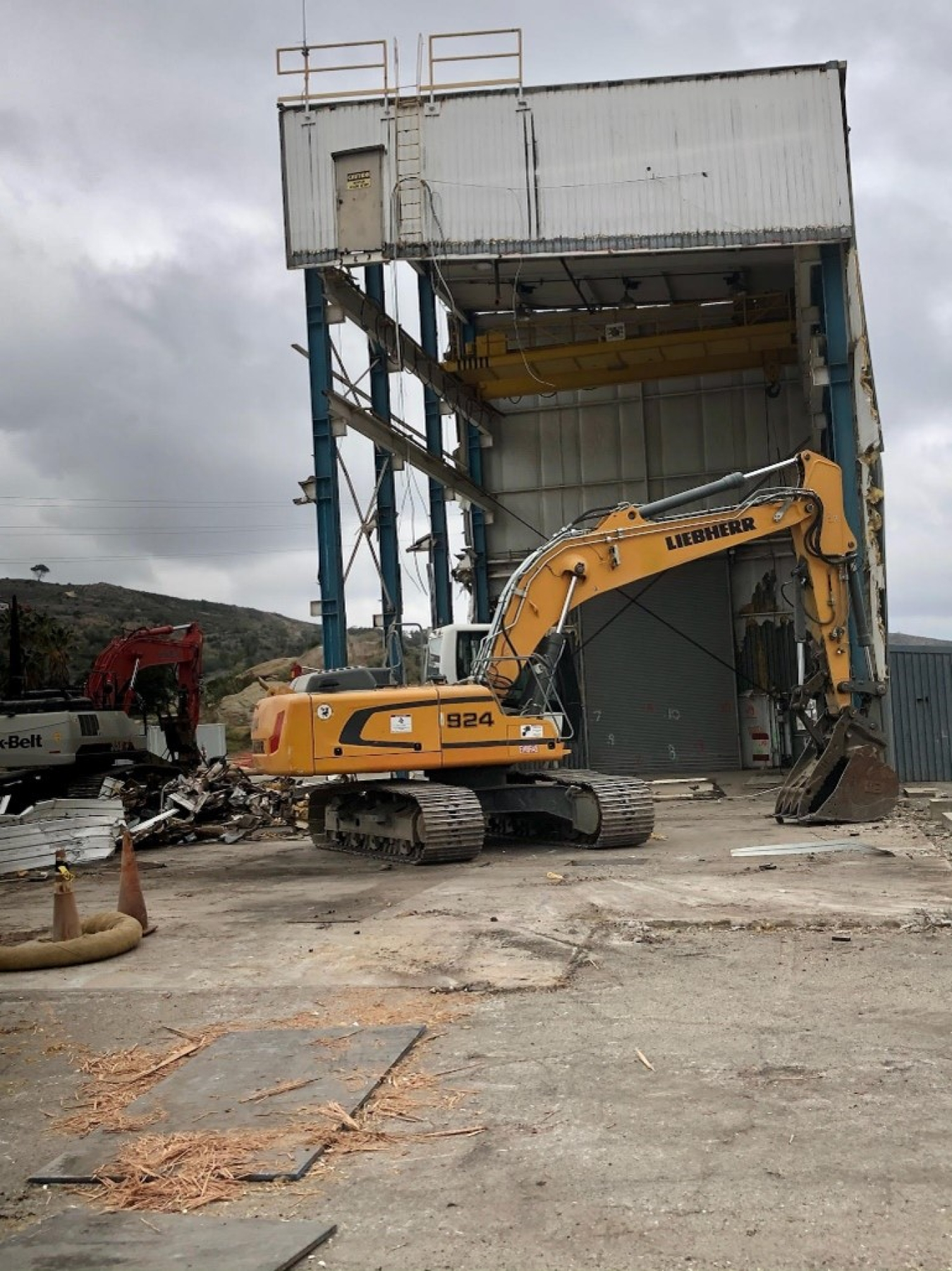 Here, workers remove panels from one of the remaining buildings in preparation for final demolition. After that teardown, only three of the DOE-owned buildings will remain to be taken down.