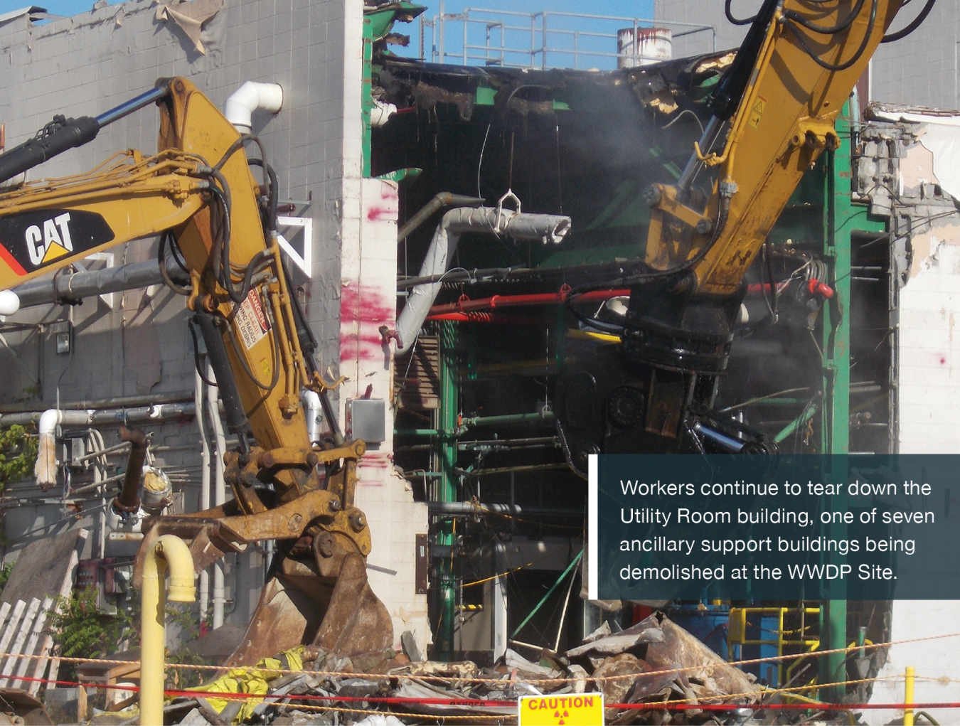 Workers continue to tear down the Utility Room building, one of seven ancillary support buildings being demolished at the WWDP Site.