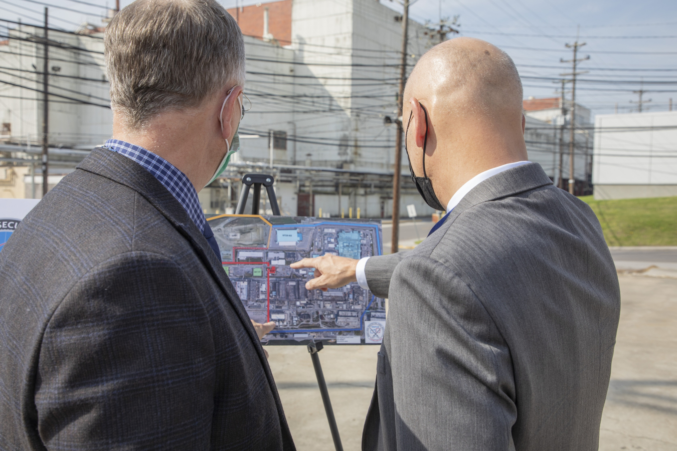 Officials examine a site plan for the WEPAR project at Y-12 National Security Complex.