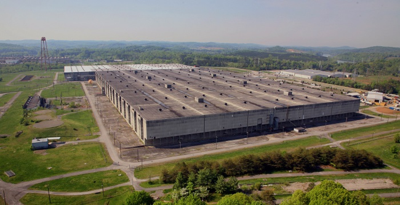 A view of the massive K-31 and K-33 gaseous diffusion uranium enrichment buildings before EM crews demolished them. The Oak Ridge Office of Environmental Management removed more than 500 structures, including these two buildings, with a combined footprint spanning more than 13 million square feet. This effort eliminated hazards and cleared land for reuse by the community for economic development at the East Tennessee Technology Park.