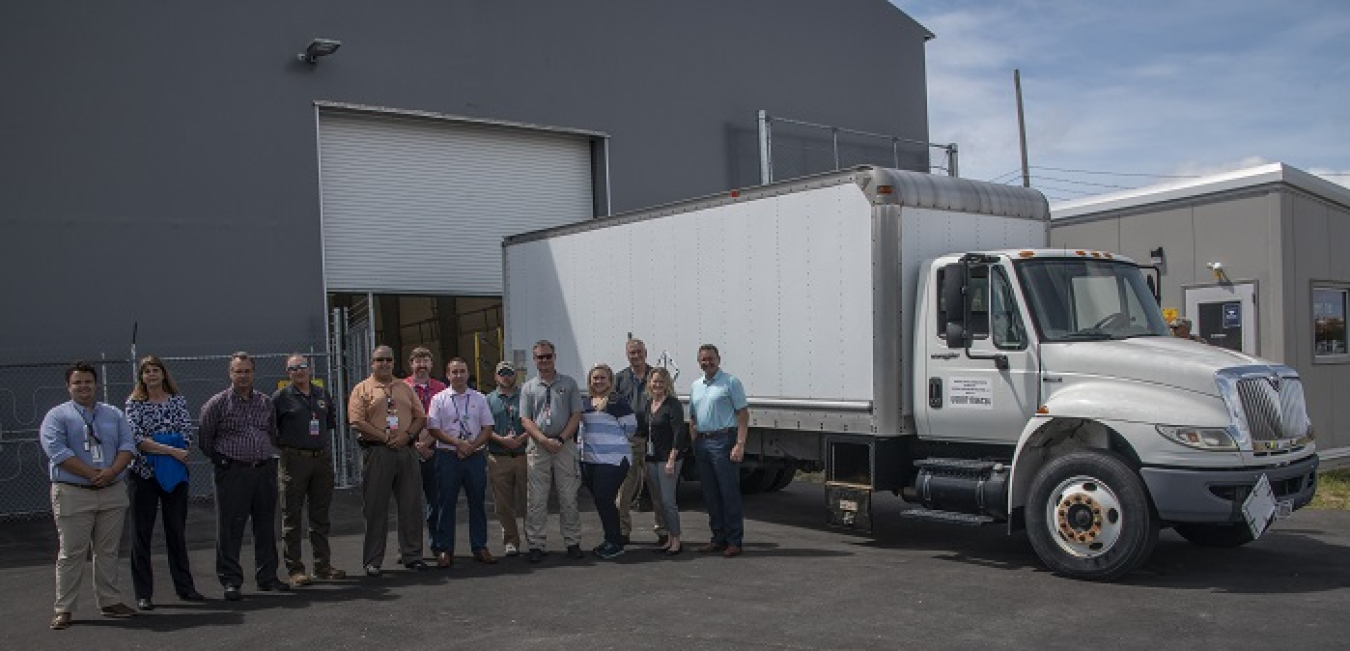 Members of the Savannah River Site K Area Characterization and Storage Pad team and their management celebrate the delivery of the first Criticality Control Overpack drum to the pad.