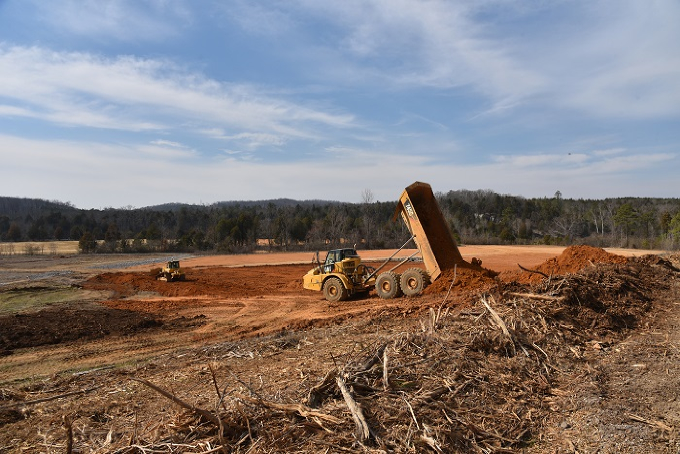 Crews used more than 2,000 truckloads of topsoil to recontour a portion of the former Powerhouse Area at Oak Ridge. UCOR employees identified an innovative approach to avoid costs and enhance efficiency by grading down a nearby ridge to obtain soil for the work.