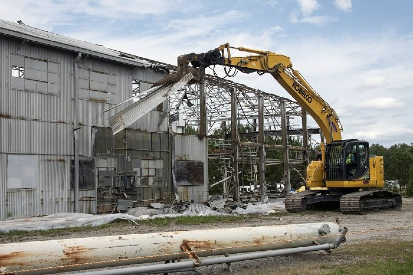 Workers demolish a section of the metal roof over the Ford Building at the Savannah River Site. At the height of the Cold War, the facility was used to test components used in five nuclear reactors at the site.