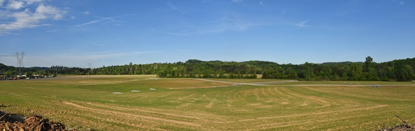 A view of a 21-acre portion of the Powerhouse Area at Oak Ridge where workers backfilled, contoured, and hydroseeded. This land is being proposed for future recreational development.