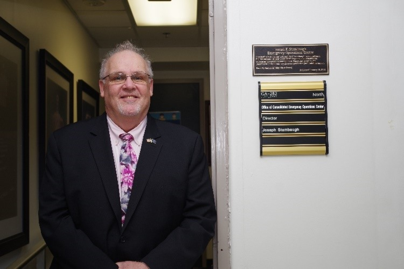 Joe Stambaugh in front of the newly named CEOC facility