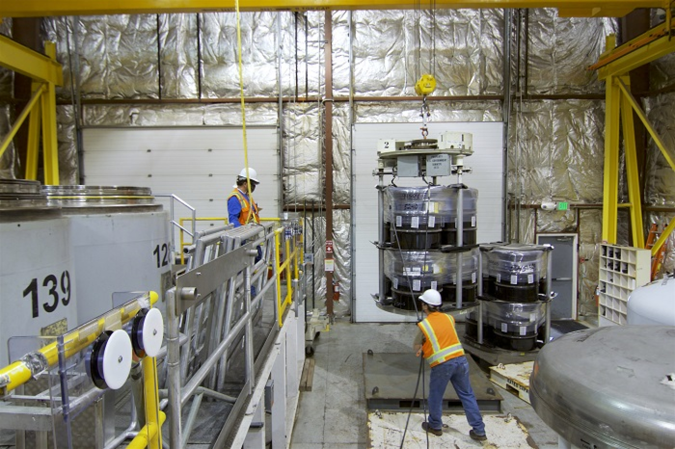 Crews at the Idaho National Laboratory Site prepare to load certified transuranic waste into a TRUPACT-II container for shipping to EM's Waste Isolation Pilot Plant.