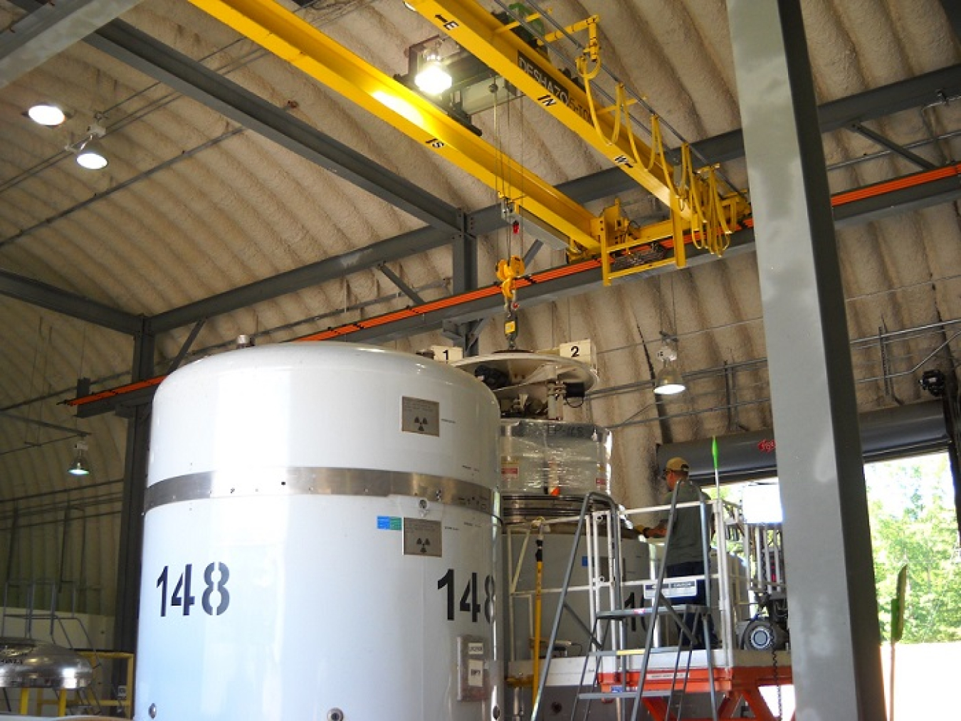 Workers at the Transuranic Waste Processing Center in Oak Ridge load contact-handled transuranic waste drums into TRUPACT-II shipping containers for shipment to the Waste Isolation Pilot Plant.