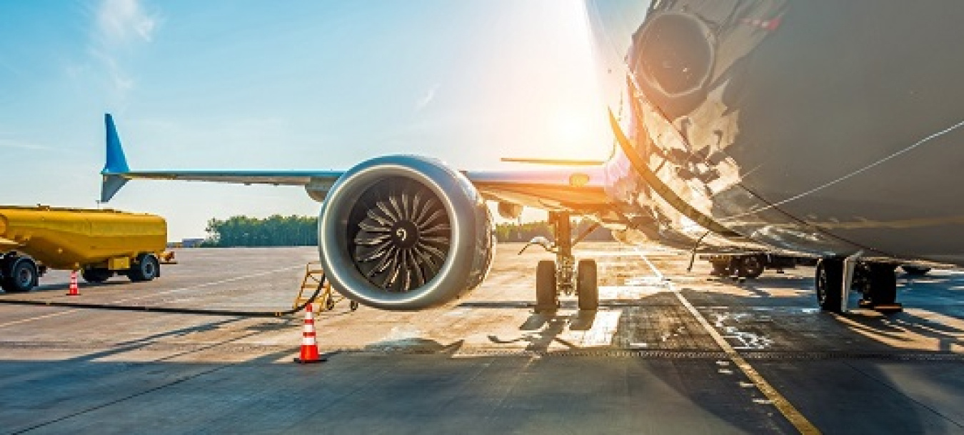 a photo of the right wing and engine of a jet.