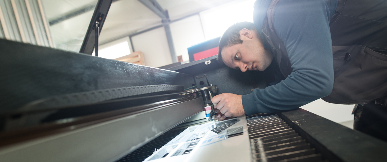 Electrical engineer repairs CNC computer numerical control laser cutting head