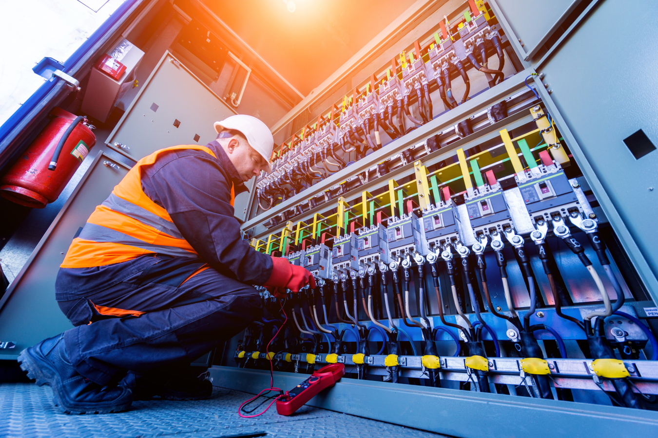 Engineer checking the operating voltage levels of the solar panel switchgear compartment