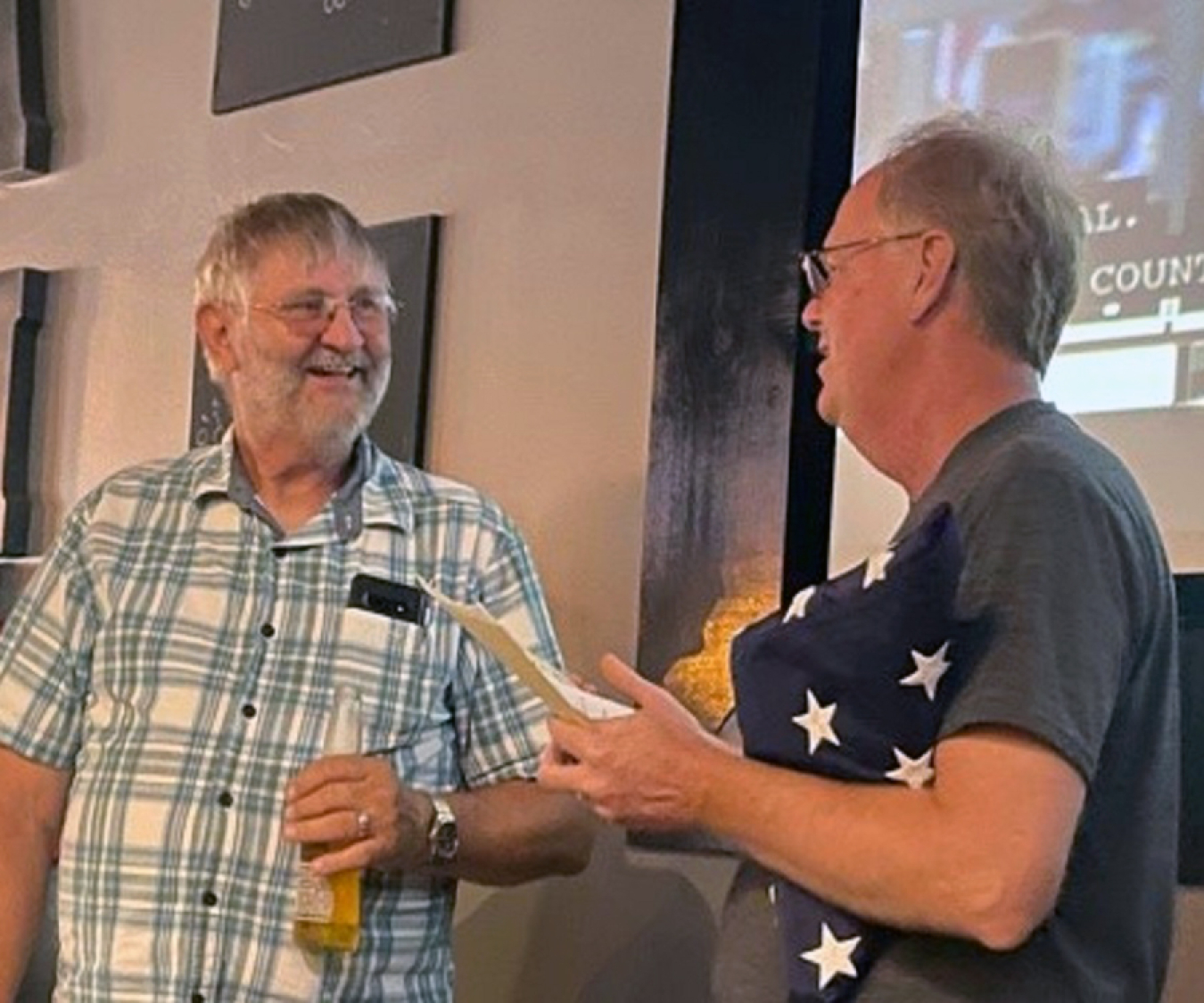 LM’s Jay Glasscock presents retiring Ed Cotter with a U.S. flag that flew over the Capitol.