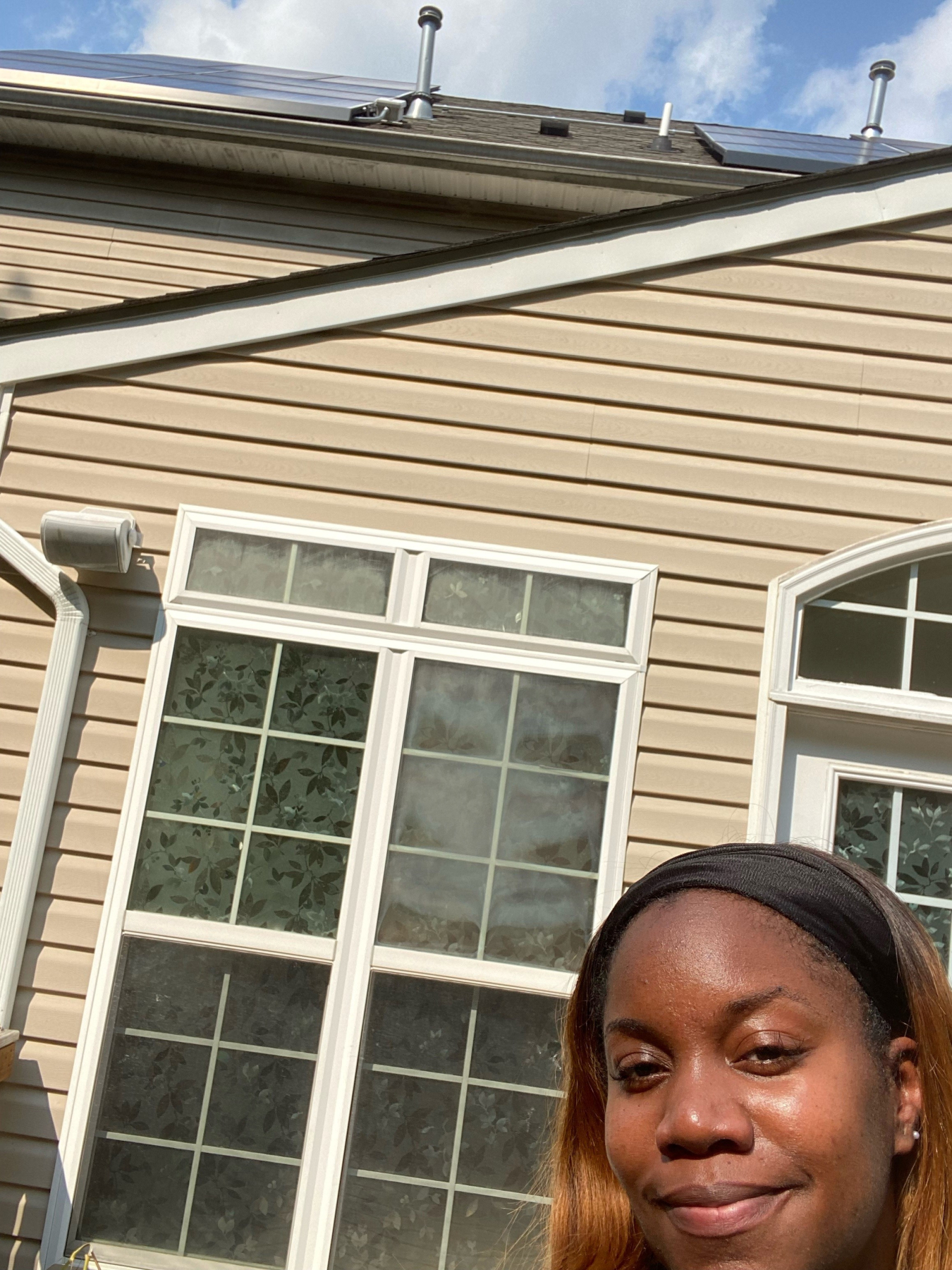 Lakisha Harris in front of her solar home.