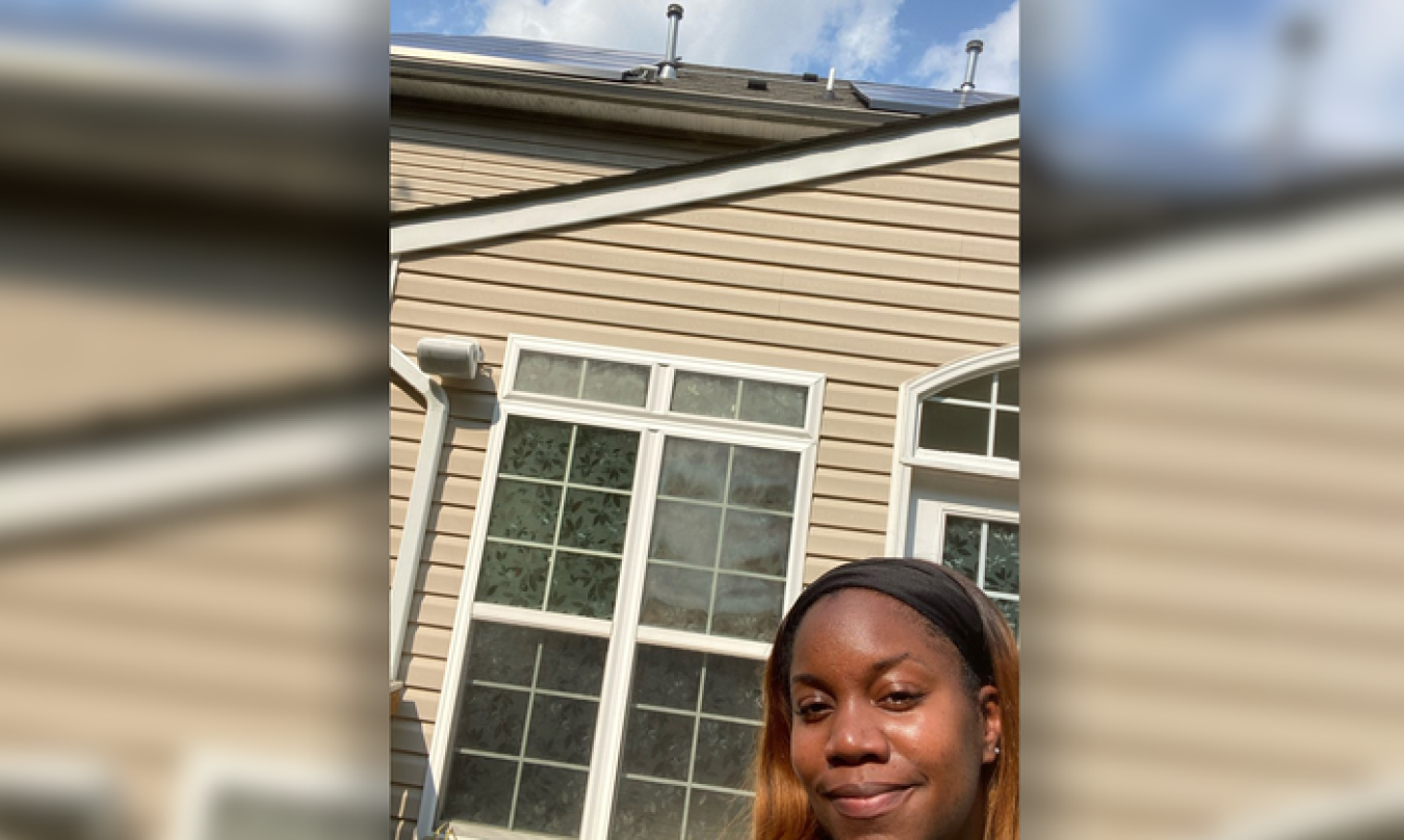 Selfie of Lakisha Harris with her rooftop solar system