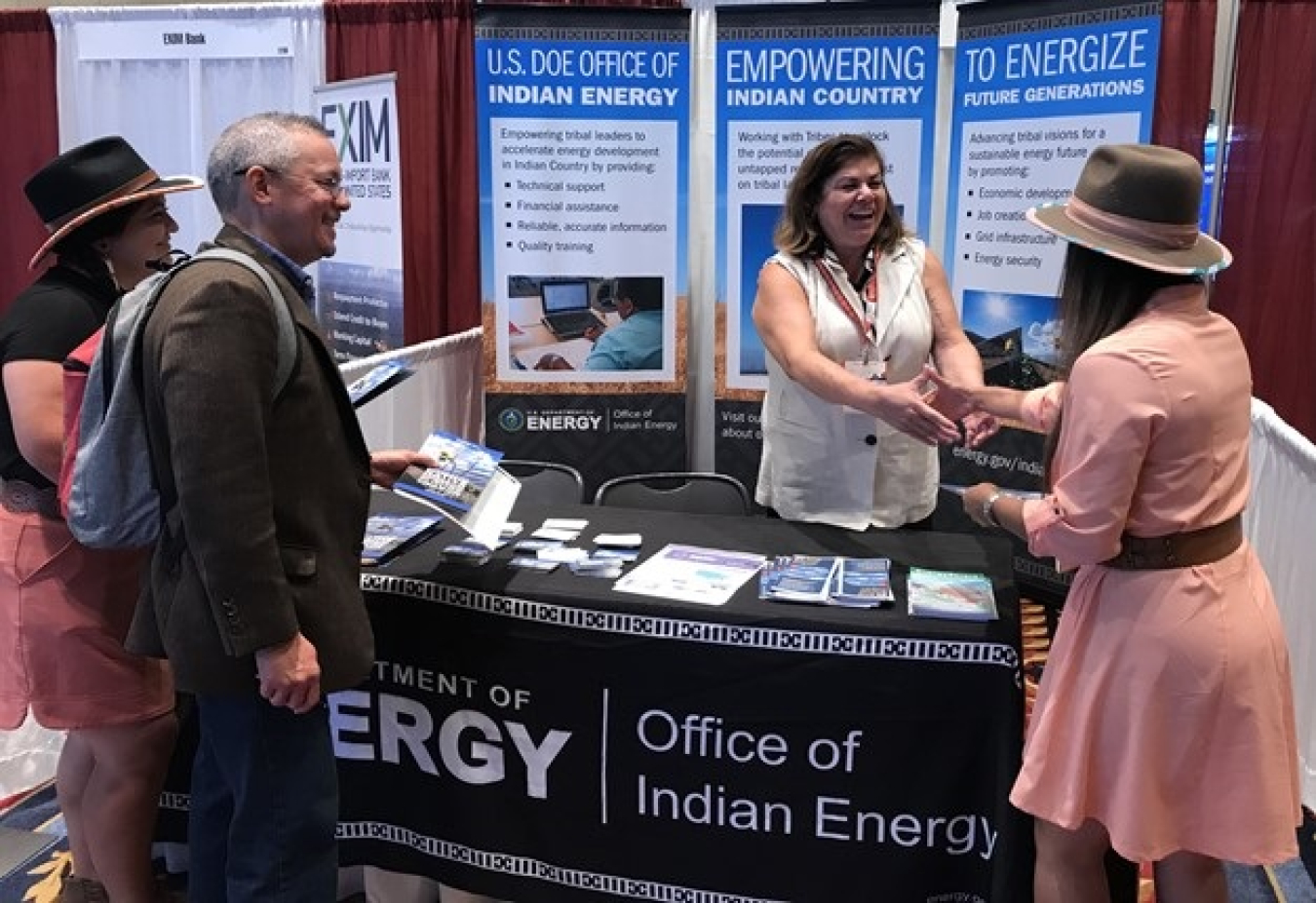 EM Tribal Affairs Program Manager Jill Conrad shakes hands with Stacia Greene, a Nez Perce tribal small business owner, and greets other Reservation Economic Summit 2021 attendees.