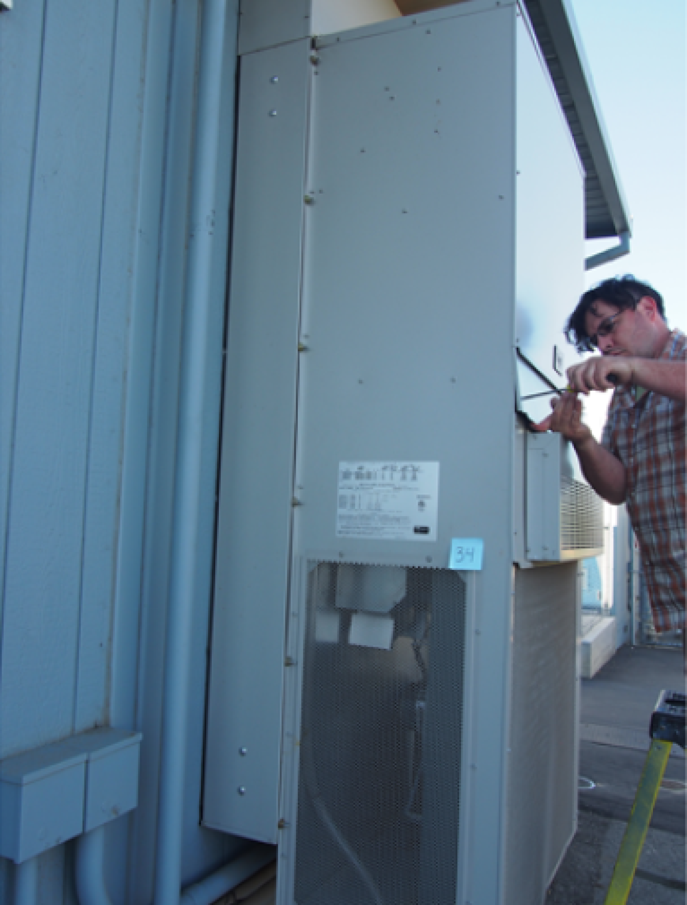 A man working on an HVAC unit.