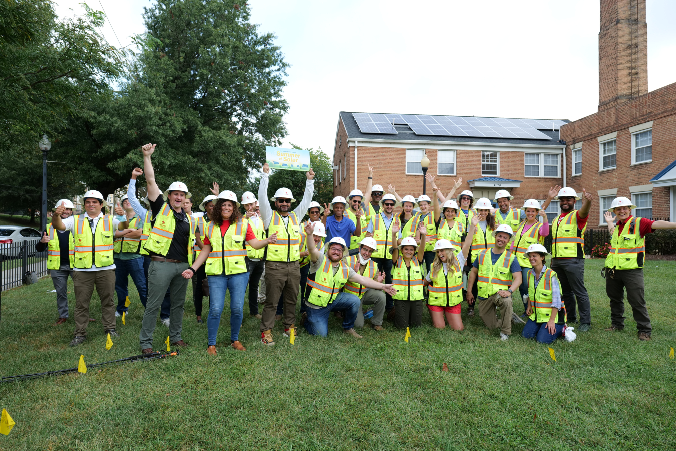 The team that completed the community solar installation celebrates outside of Crescent Park Village in Washington, DC.