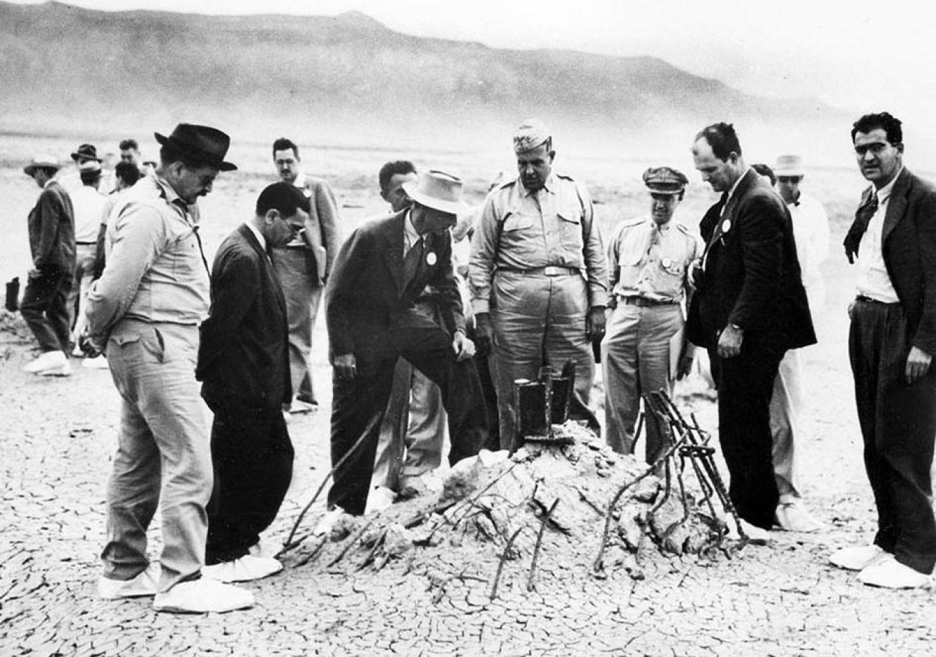 Gen. Leslie Groves, center, and Robert Oppenheimer, leaning on one knee, are pictured at the Trinity Site in New Mexico on Sept. 9, 1945. In the book “Atomic Doctors,” this photo is described as a “public relations stunt” designed to counter medical professionals’ concerns about the effects of radiation after an atomic bomb detonation.