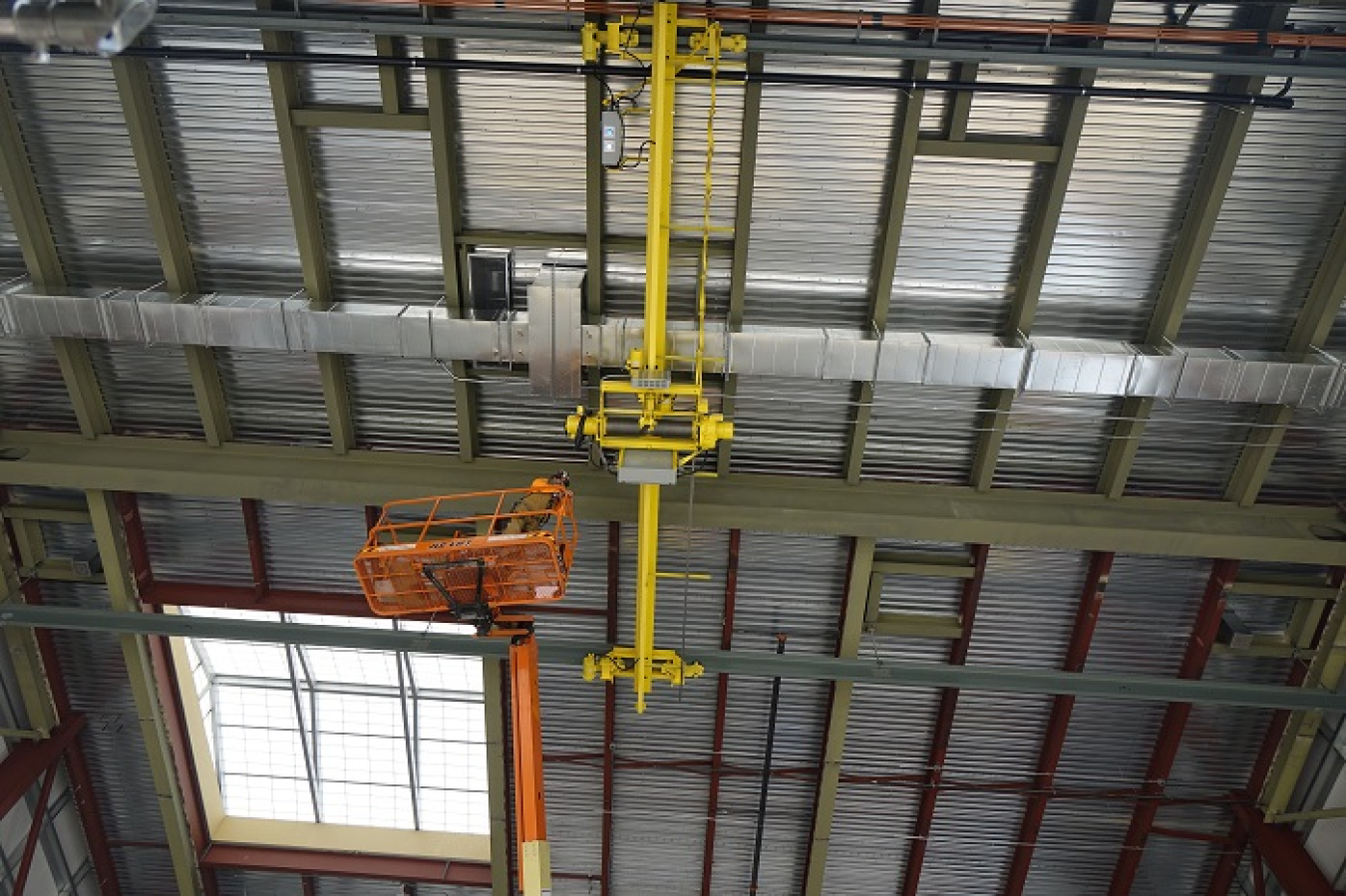 Pictured on a lift, Rick O’Hair, a rigger with crane consultant Paul Parish Ltd., monitors a ceiling-mounted crane at the Low-Activity Waste Melter Assembly, Storage and Transportation facility near the Hanford Site during recent load testing.