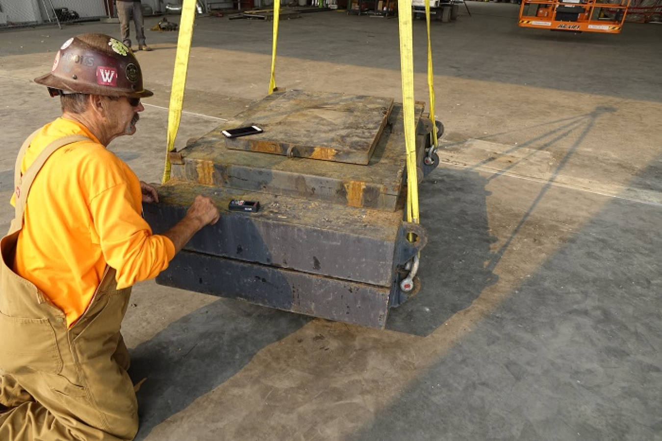 Rick O’Hair, a rigger with crane consultant Paul Parish Ltd., checks a device that measures the distance a crane has carried a test load to ensure the crane is working properly and can handle the loads needed to complete the assembly of replacement melters for the Waste Treatment and Immobilization Plant at the Hanford Site.