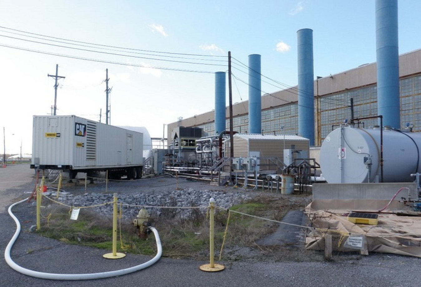 Pictured here are the equipment, tanks, and other items on the east side of the C-400 Cleaning Building at the Paducah Site. These items were removed, in part, to prepare for a remedial investigation that will allow EM to evaluate the source of off-site groundwater contamination located under the building.