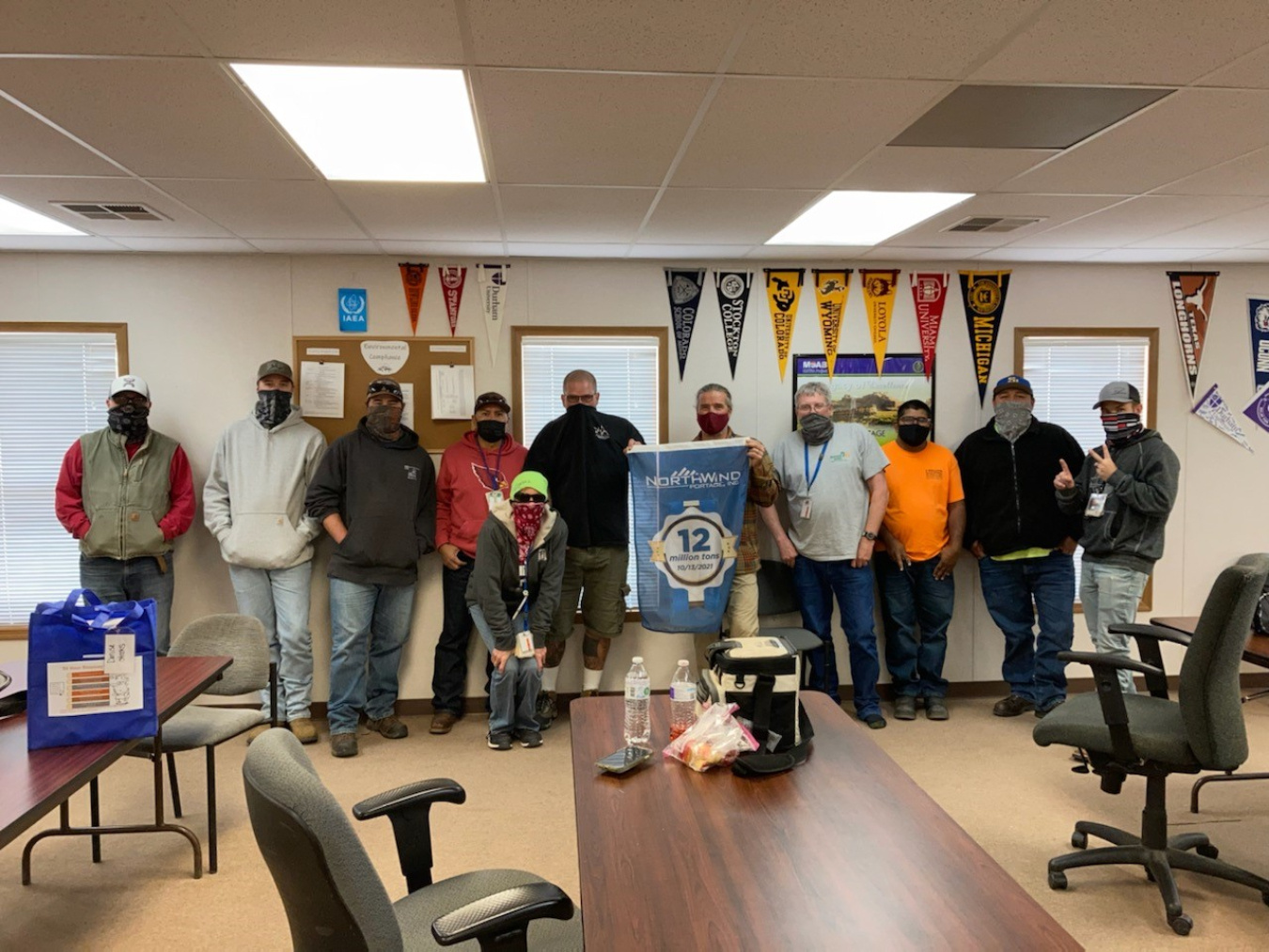 Members of the crew that helped the Moab Uranium Mill Tailings Remedial Action Project achieve the milestone of relocating 12 million tons of uranium mill tailings to the Crescent Junction disposal cell celebrate following their accomplishment.