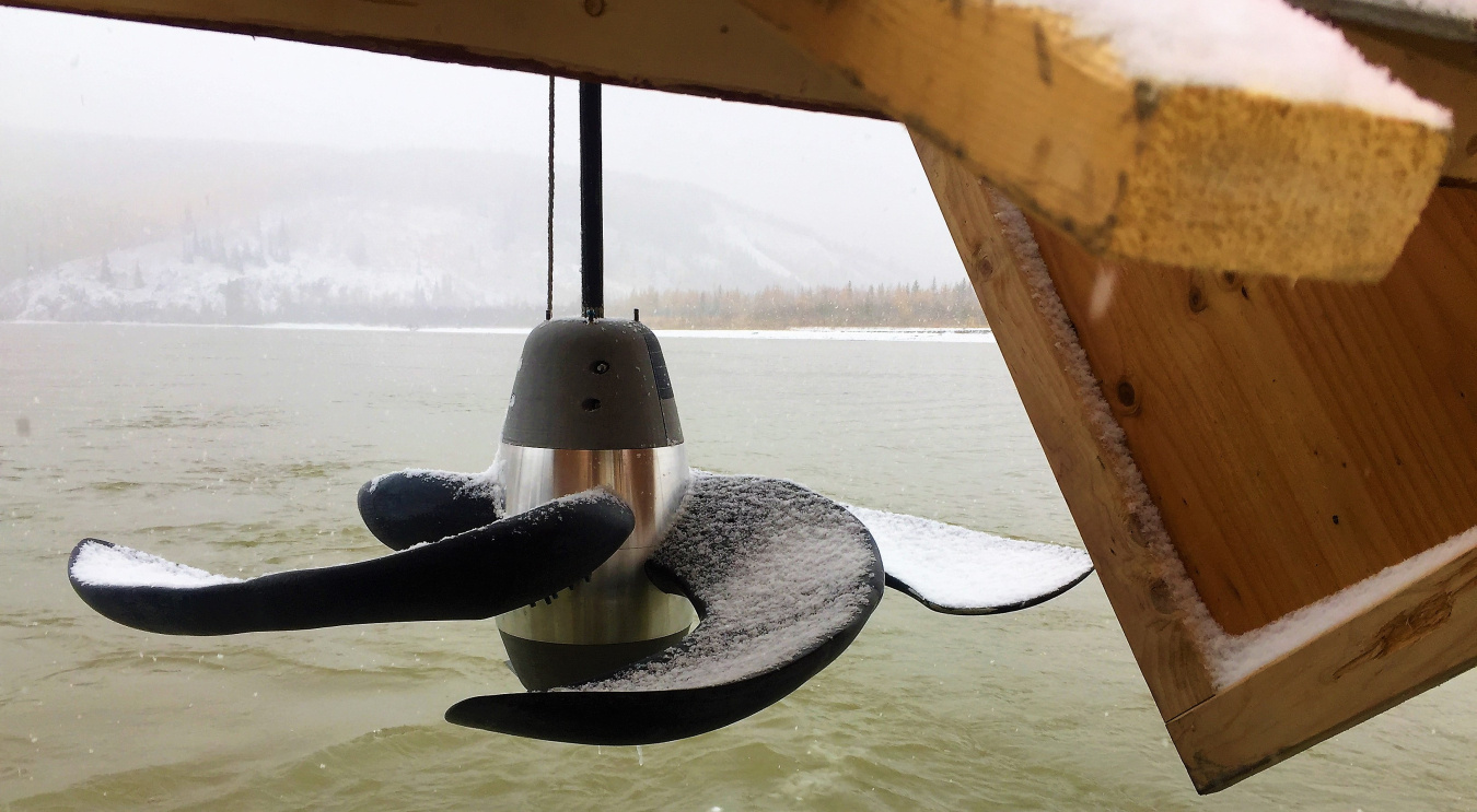 A hydrokinetic device that Bladerunner designed is lowered into the Tanana River for testing. 