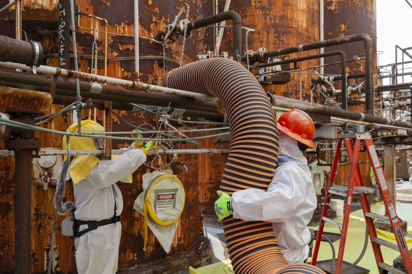 Oak Ridge workers remove mercury and mercury-contaminated solids from process pipes in the column exchange, or COLEX, equipment at the Alpha-4 facility at the Y-12 National Security Complex.