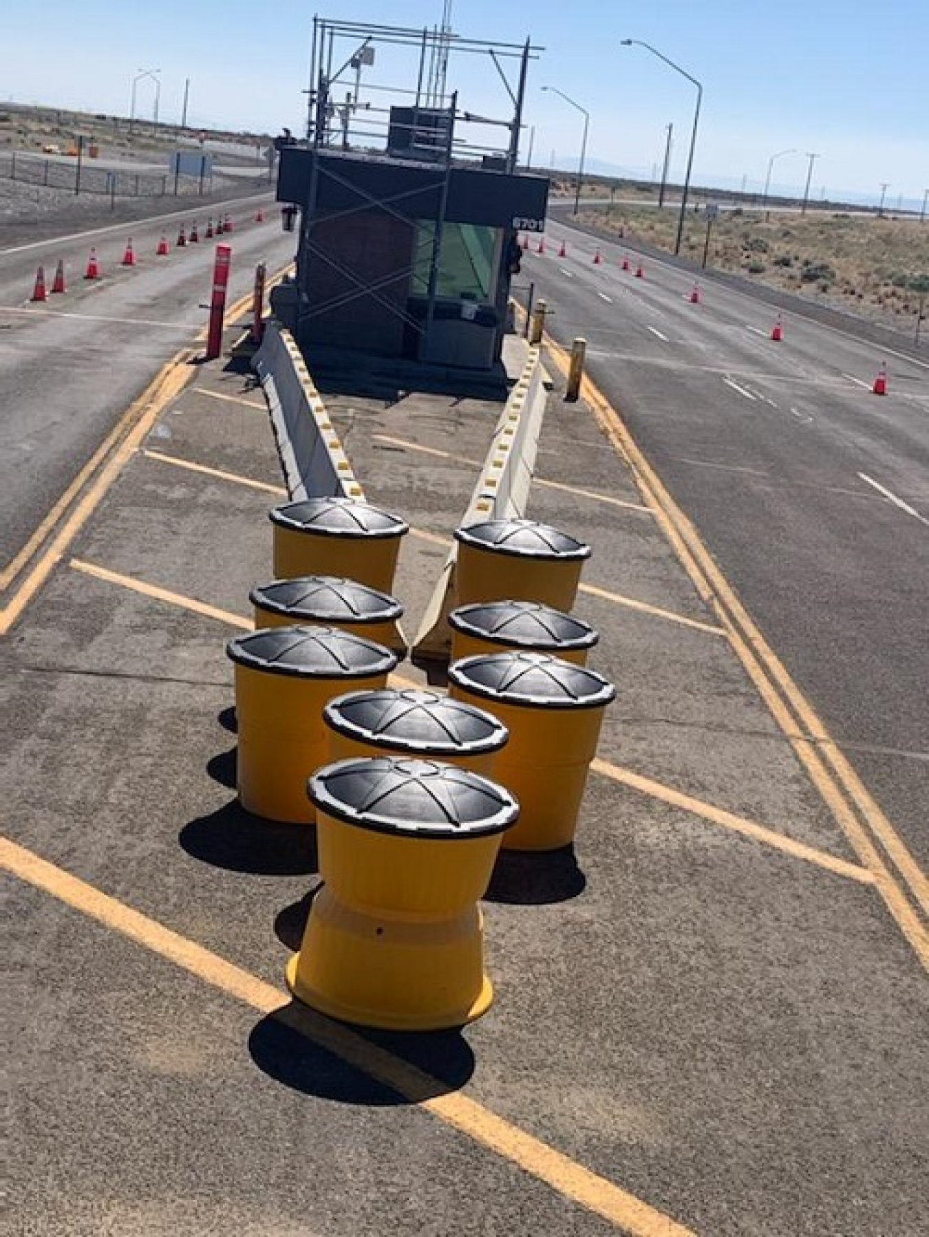 After: Improvements to a vehicle security barricade on the Hanford Site include a permanent concrete barrier used in conjunction with sand barrel barriers to protect the guardhouse and patrol staff.