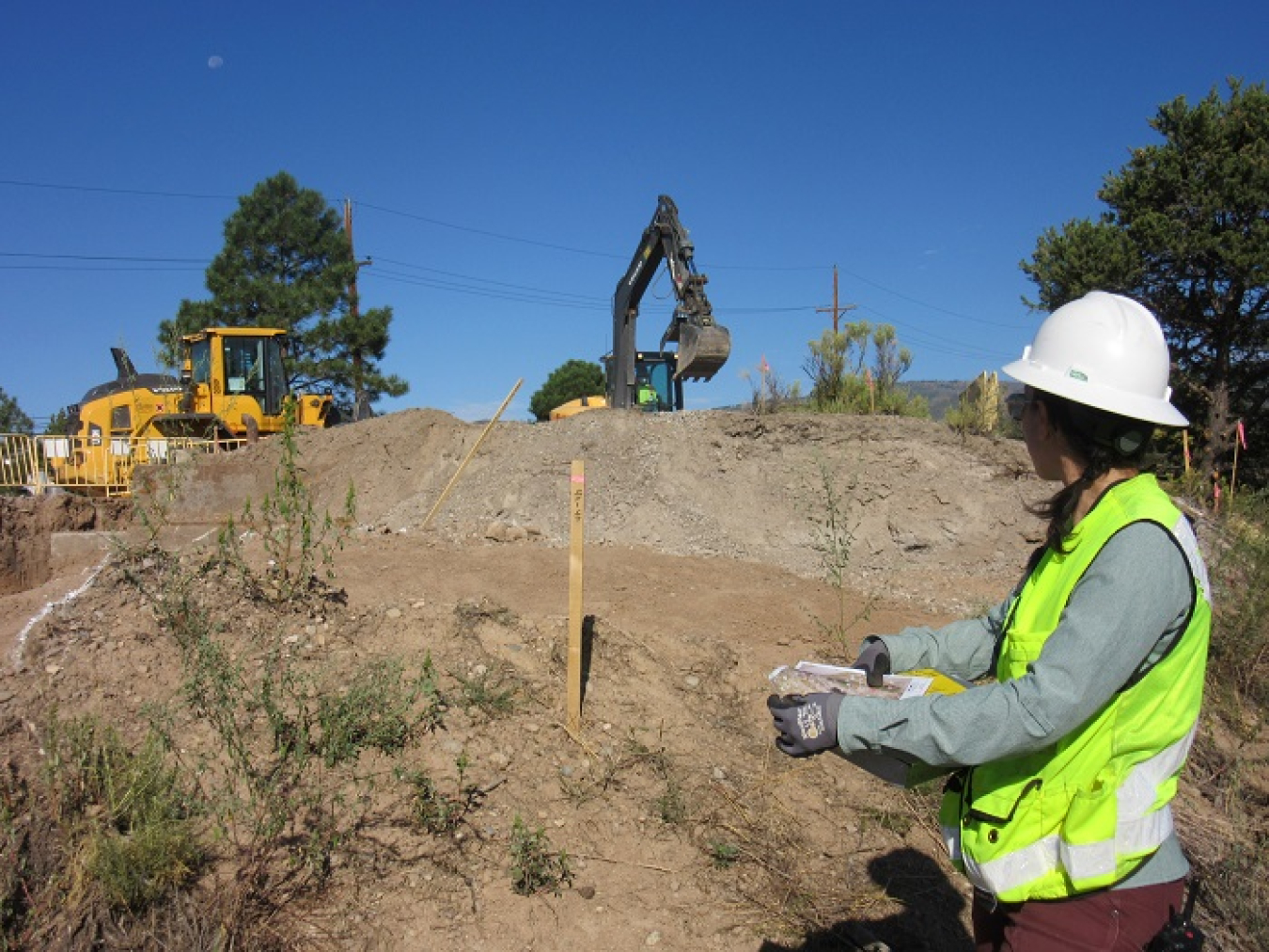 Tessa Hermes, assistant project manager and senior geologist with Newport News Nuclear BWXT Los Alamos (N3B) subcontractor TerranearPMC, assesses the excavation of contaminated soil near one of Los Alamos National Laboratory’s Cold War-era underground explosives firing chambers. The site is part of N3B’s Southern External Boundary Campaign to clean up Lower Water Canyon.