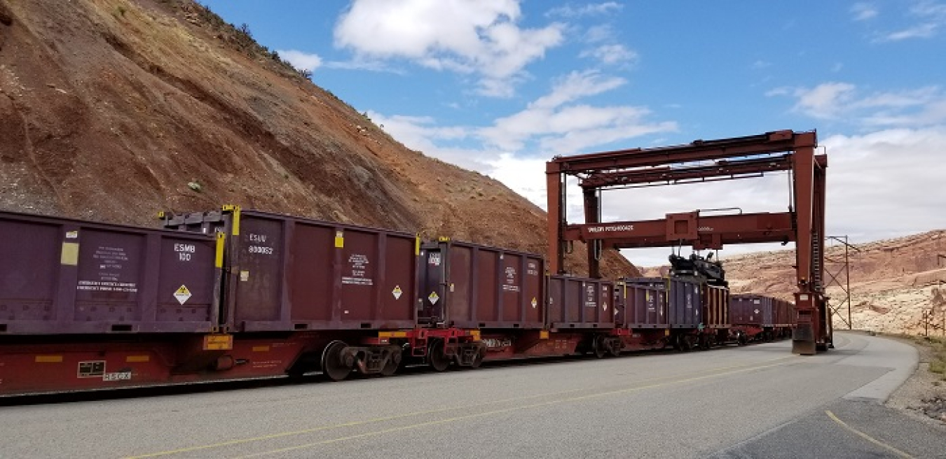 Sealed steel containers are loaded onto railcars at the Moab Uranium Mill Tailings Remedial Action Project site in preparation for transport of uranium mill tailings to the Crescent Junction disposal cell, 30 miles north of Moab.