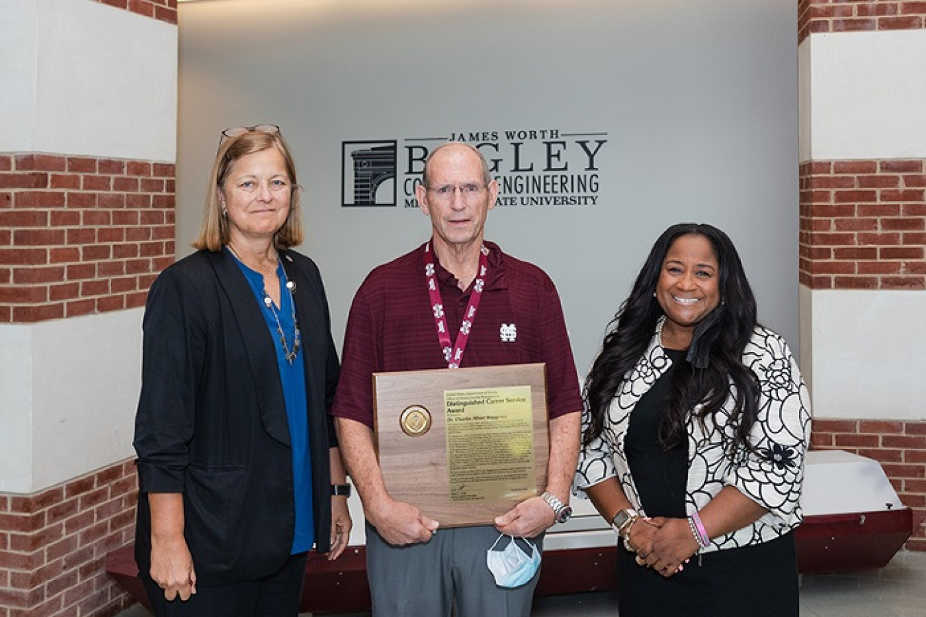 Charles Waggoner, center, former director of Mississippi State University’s (MSU) Institute for Clean Energy Technology, has been recognized with DOE’s Distinguished Career Service Award. MSU Vice President for Research and Economic Development Julie Jordan, left, and EM Associate Principal Deputy Assistant Secretary for Field Operations Nicole Nelson-Jean presented Waggoner with the award last week.