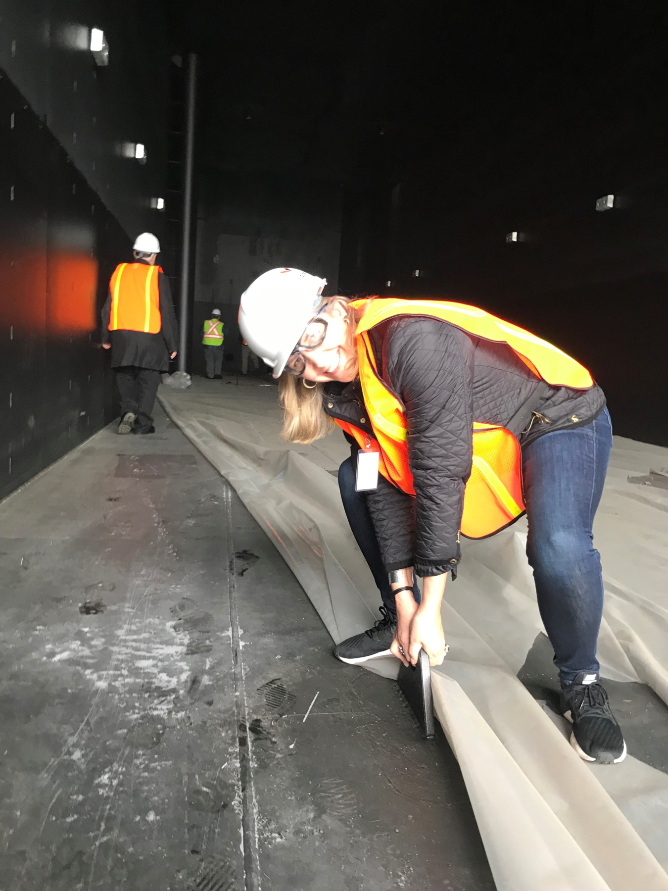 Woman performing pull tests on the mooring anchor points on an OE device.