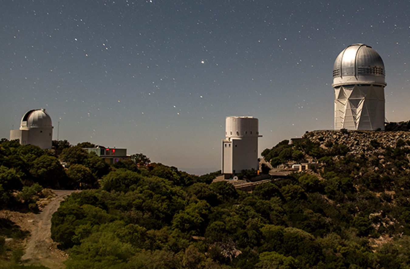 An observatory on a hill at night