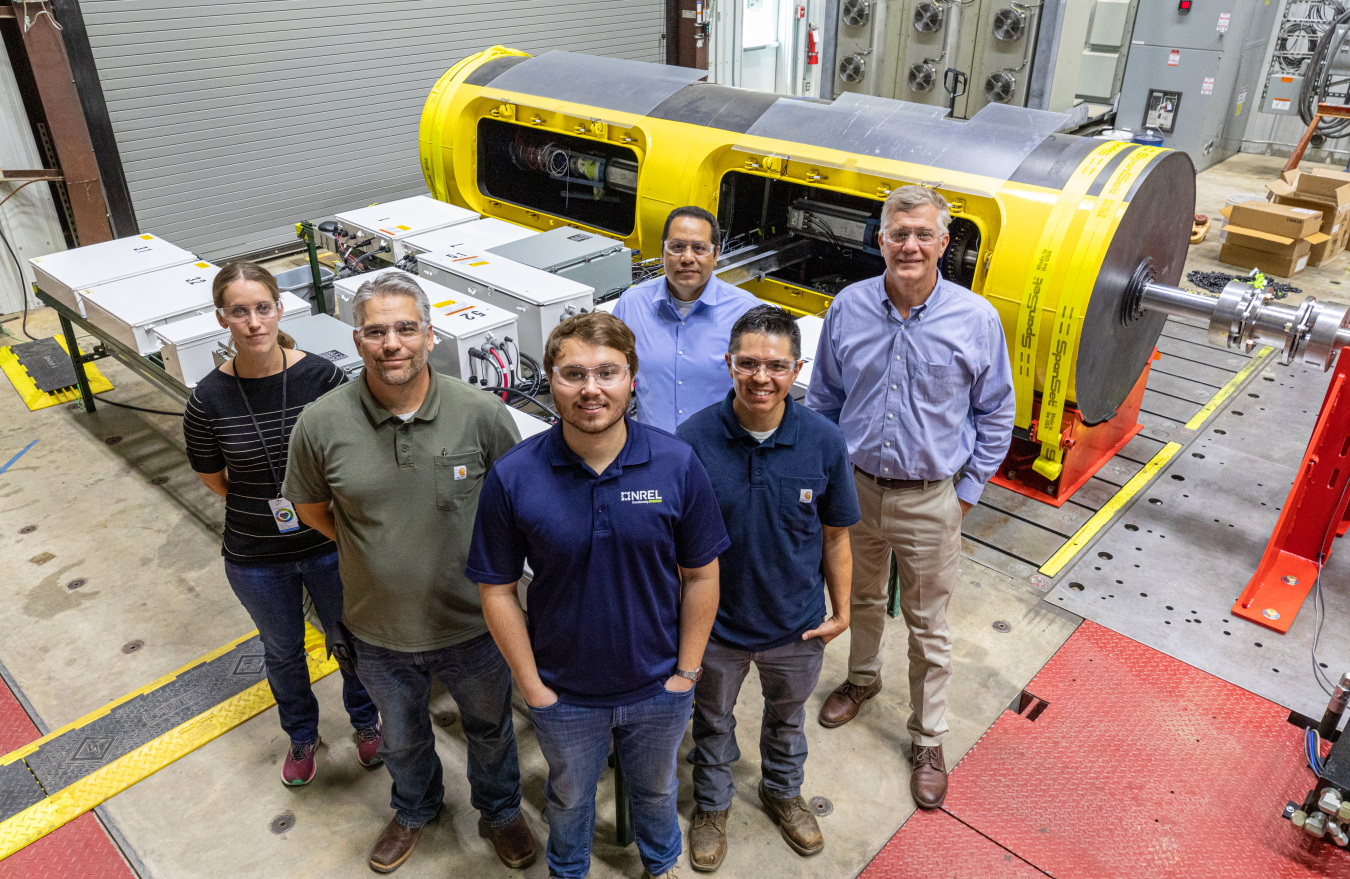 Researchers stand together smiling. 