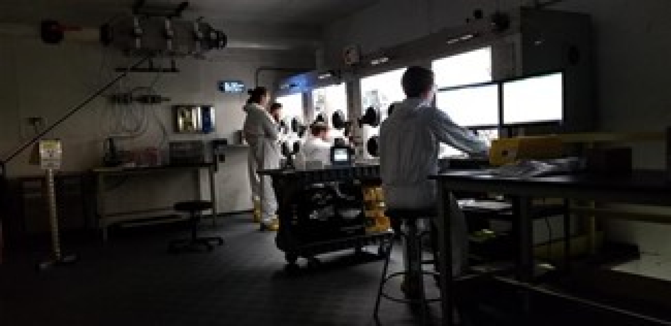 Niowave radiochemists performing isotope extractions in a hot cell