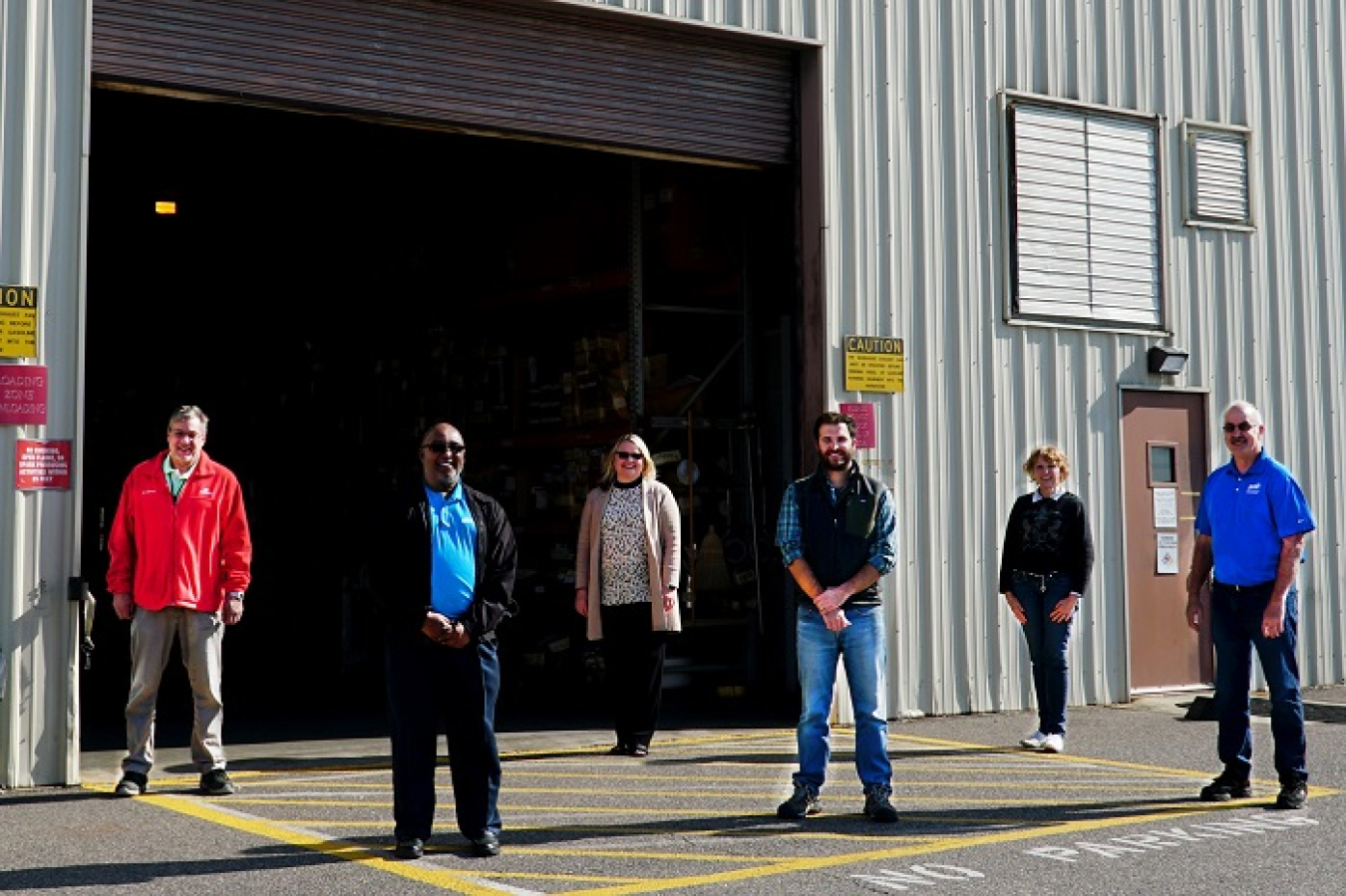 Employees representing Savannah River Remediation (SRR) and its small business subcontractor U&E Professional Services stand in front of the Material Access Center, supplied by U&E.