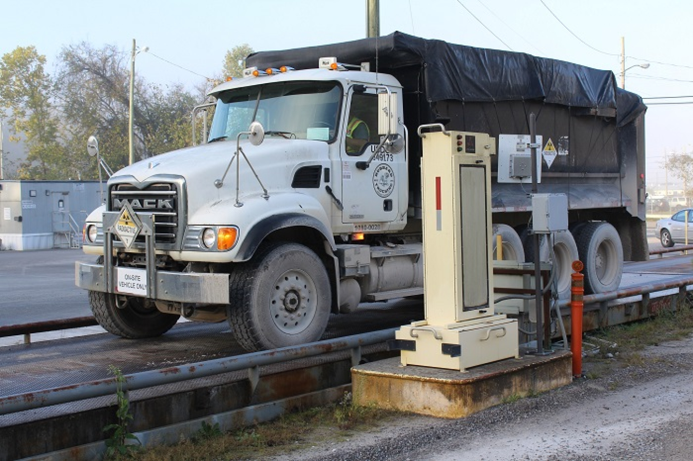 A truck loaded with waste shipments crosses the scale at the East Tennessee Technology Park at Oak Ridge. Each truck used by Oak Ridge contractor UCOR is equipped with a unique radio frequency identification card that logs its movements and weights, and registers data within a database.