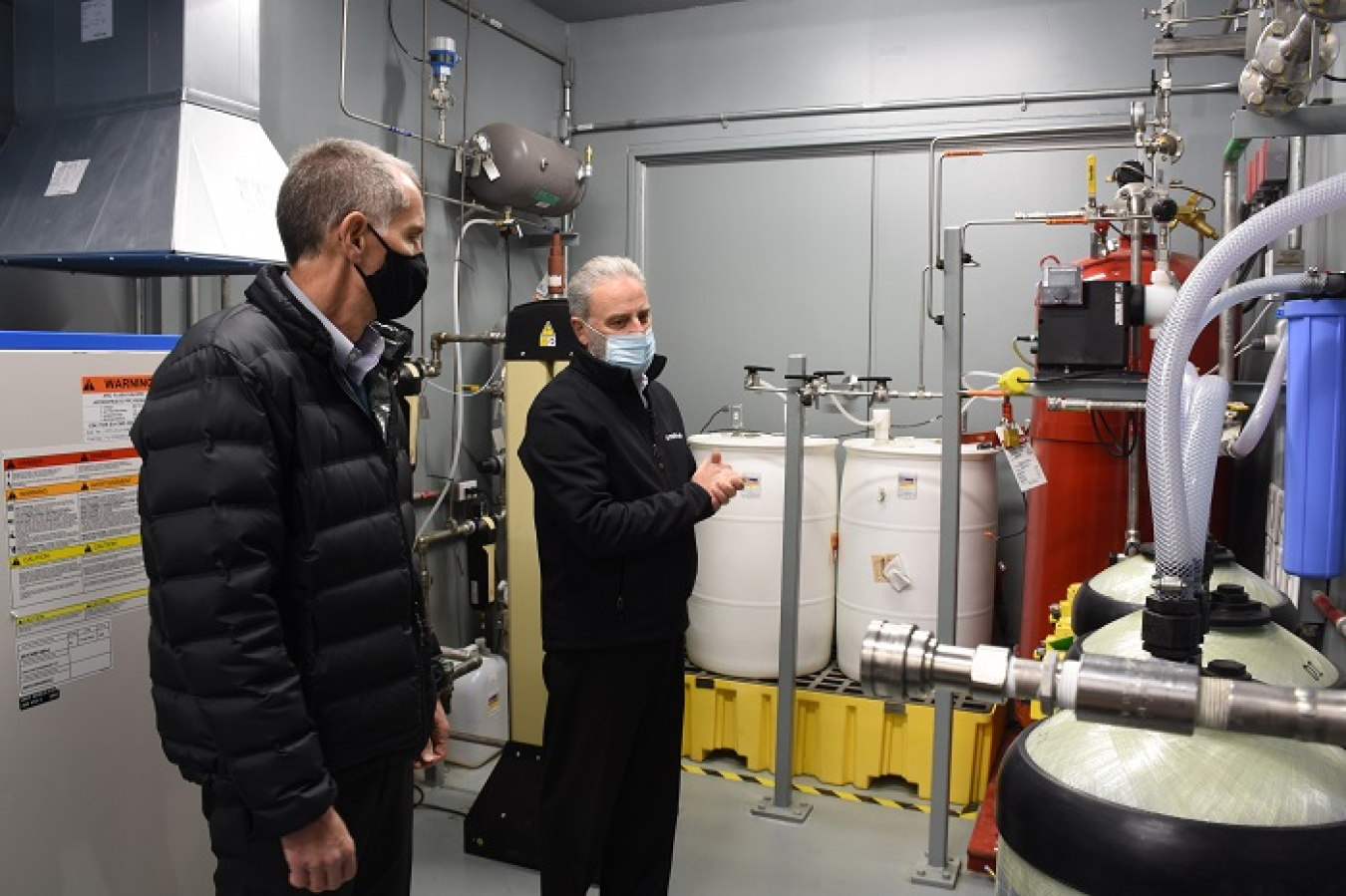 Brian Vance, manager of the Office of River Protection and Richland Operations Office, left, is given a tour of the Tank-Side Cesium Removal (TSCR) system ancillary enclosure by John Eschenberg, president and CEO of Washington River Protection Solutions.