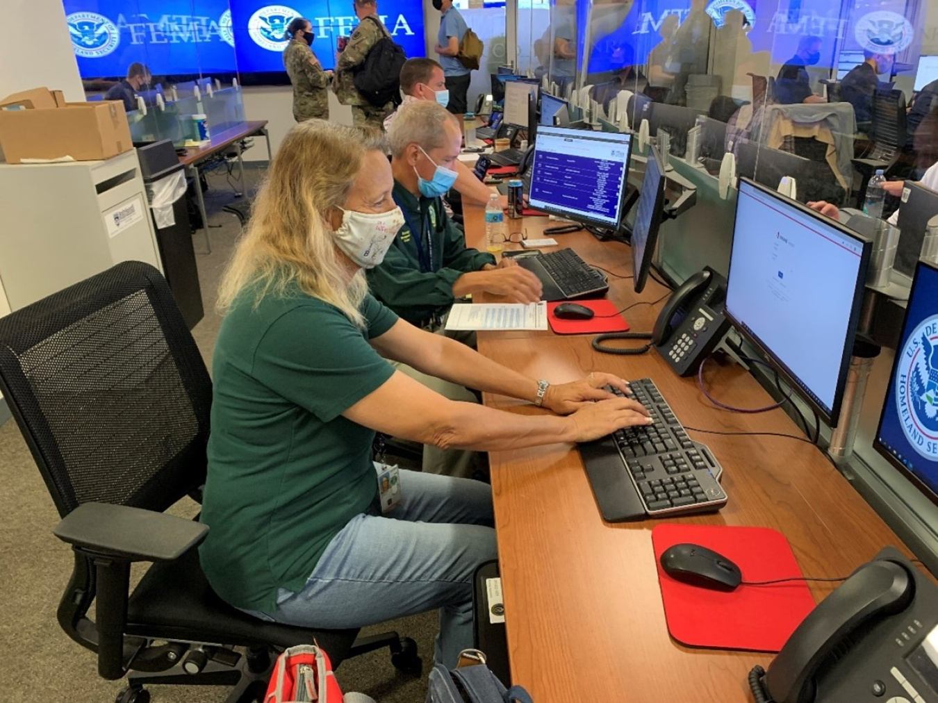 FEMA team members working at a computer in an emergency response center