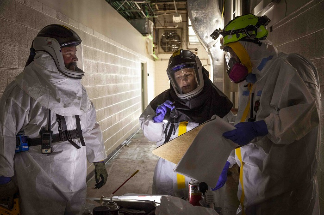 Electricians with Oak Ridge cleanup contractor UCOR discuss isolating electrical hazards at the Beta-1 facility at the Y-12 National Security Complex.