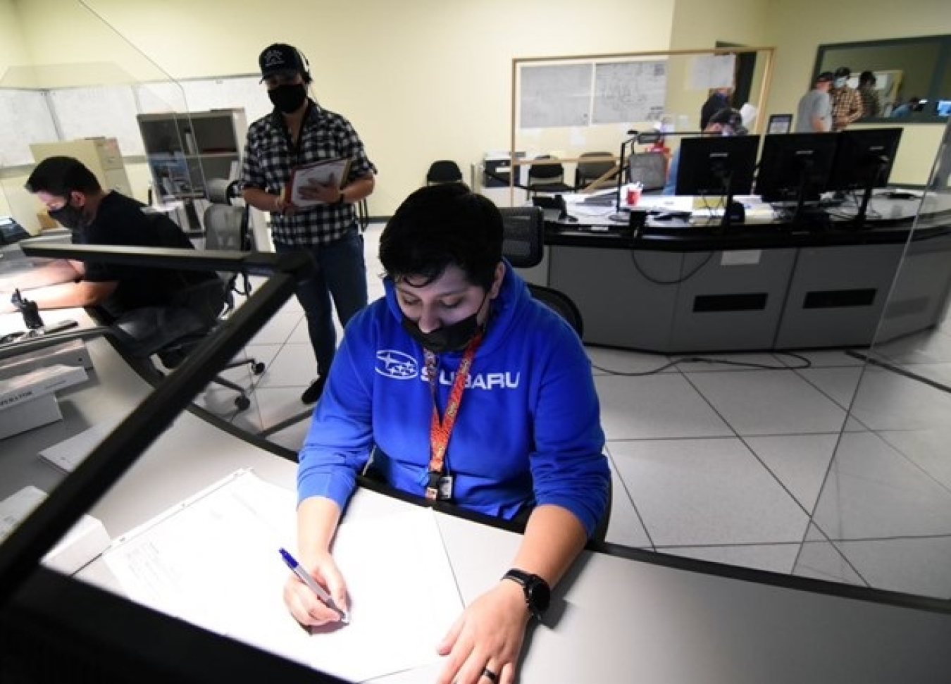 Nicholas Callihan, left, and Julissa Quinonez Chavez, front, complete training to become qualified as control room supervisor and utilities operator for the Waste Treatment and Immobilization Plant. Instructor Sara Hannickel, center, oversees their training and qualification. 