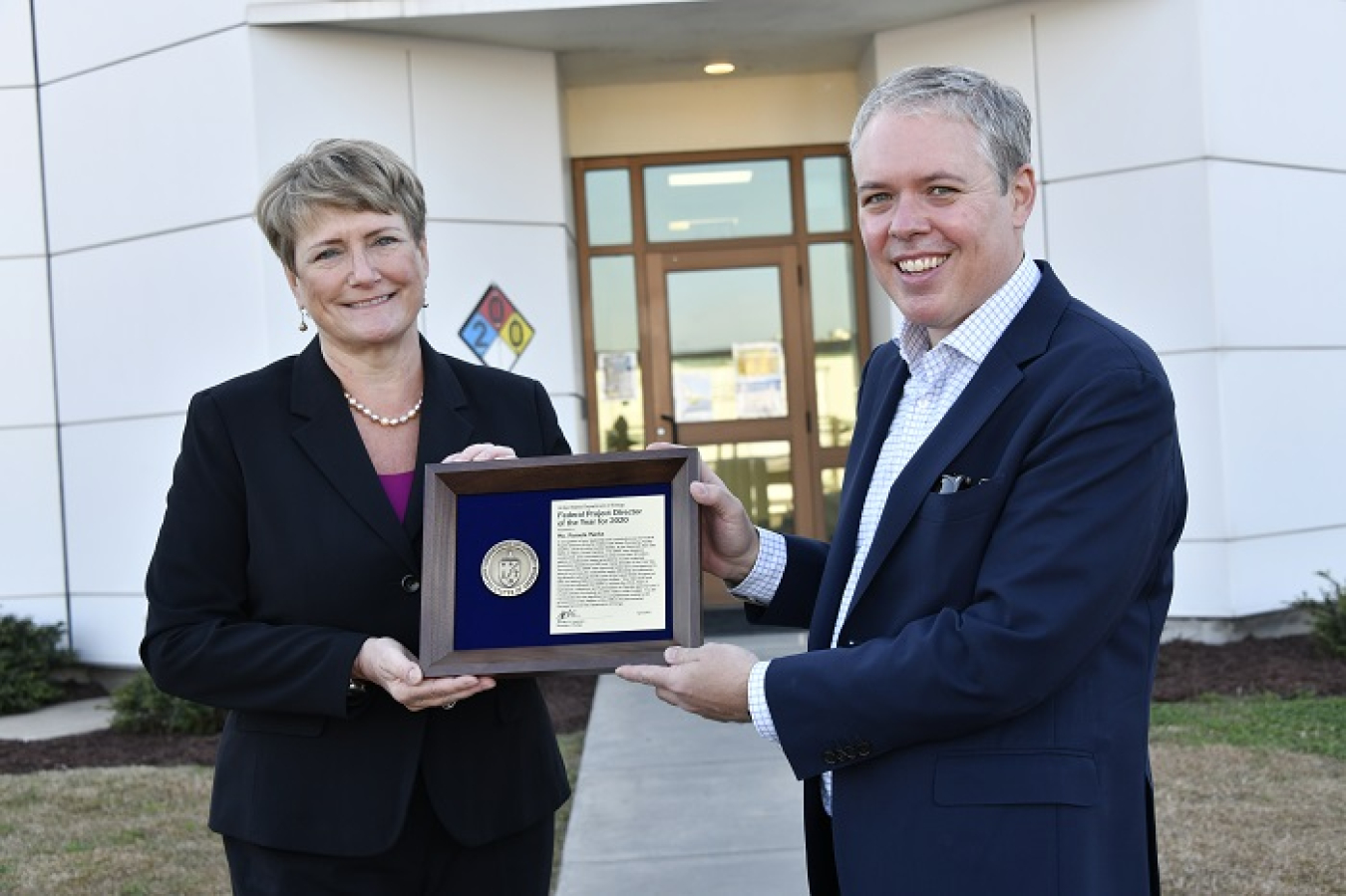 EM Senior Advisor William "Ike" White presents the DOE’s Federal Project Director of the Year Award to DOE Savannah River Operations Office Assistant Manager for Nuclear Material Stabilization Pam Marks