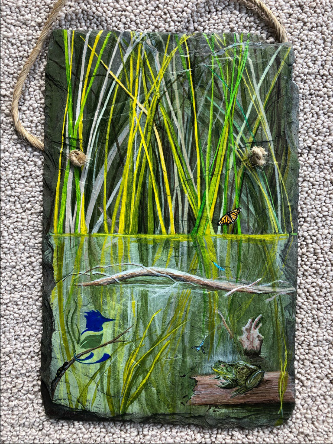 A hand painted slate, gifted to Smiley, depicting a scene from one of Fernald Preserve’s award-winning restored wetland habitats.