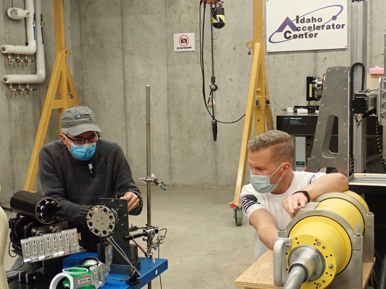 Fluor Idaho Engineer Kevin Young, left, and Idaho Accelerator Center Imaging Laboratory Director Mike Smith prepare calcine retrieval project components for radiation testing with a high-powered X-ray generator.