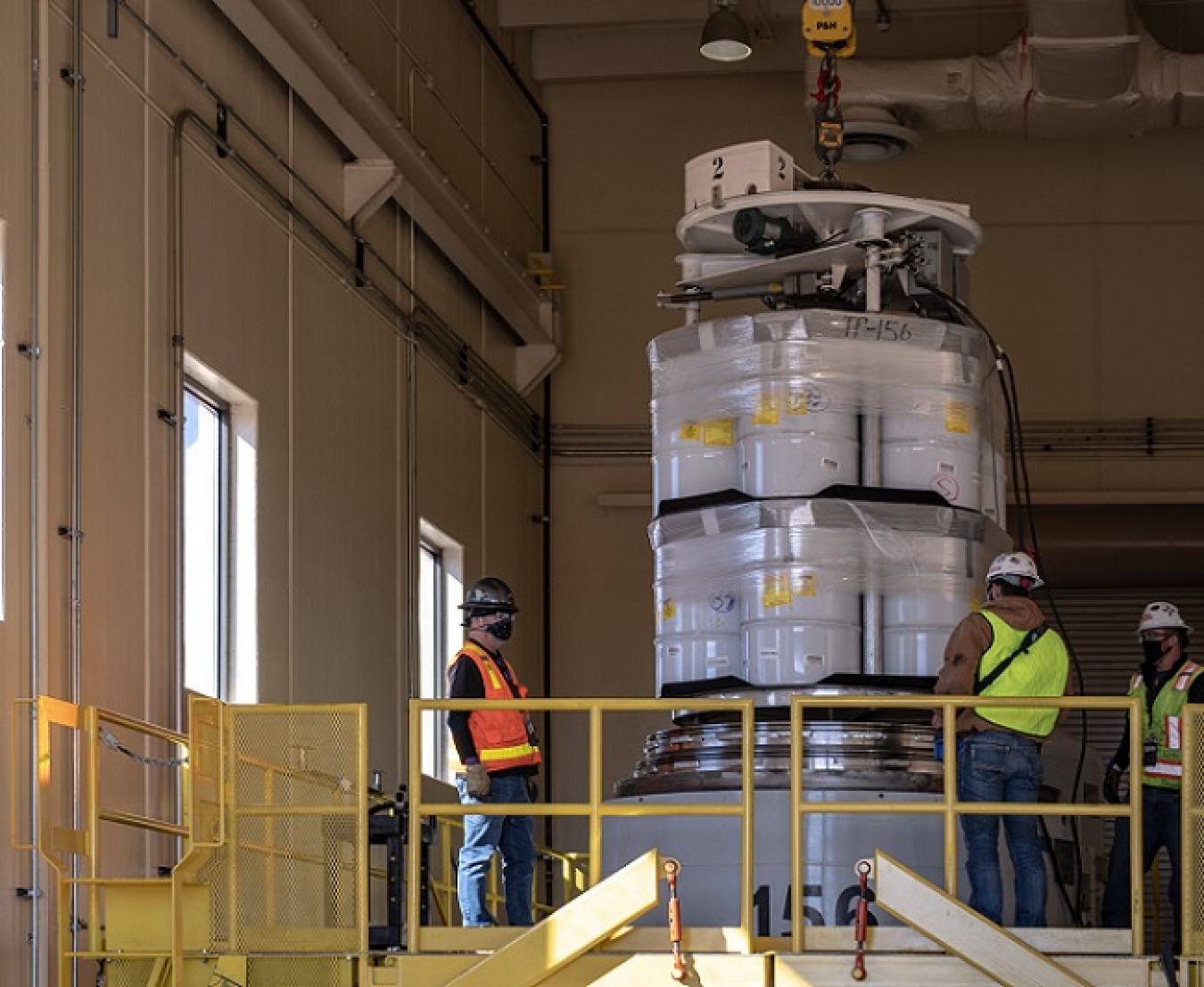 Workers at the Radioassay and Nondestructive Testing facility at the Los Alamos National Laboratory load the first comingled transuranic waste shipment from EM and the National Nuclear Security Administration.