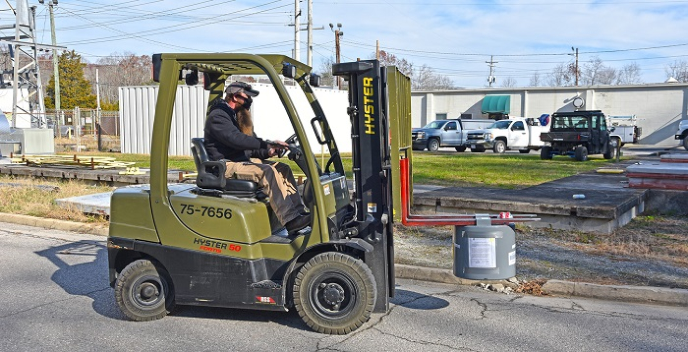 An EM worker transfers a canister of purified laboratory-grade mercury to Oak Ridge National Laboratory. EM recently transferred 1,200 pounds of the material to the laboratory to support research.