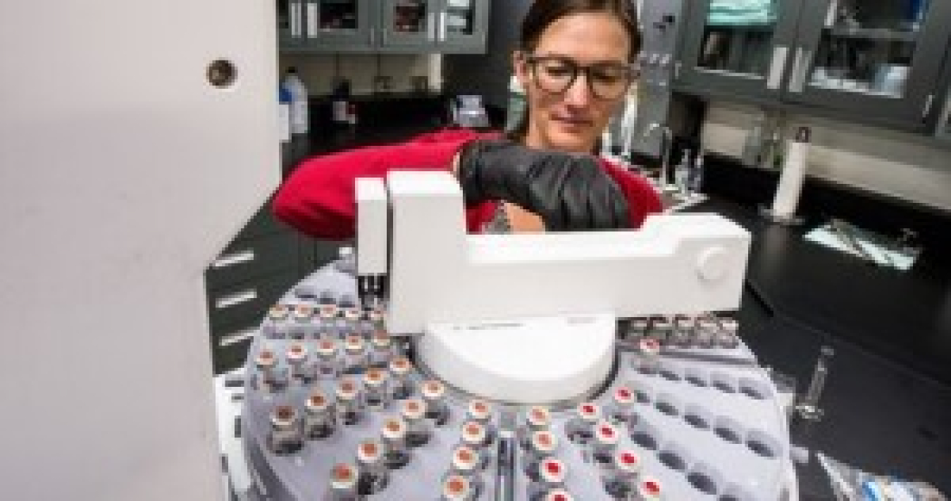 A scientist prepares vials in the Fuel Synthesis and Catalysis Laboratory at DOE’s National Renewable Energy Laboratory.